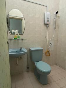 a bathroom with a blue toilet and a sink at Nur Kasih Homestay Seri Manjung in Seri Manjung +11 photos