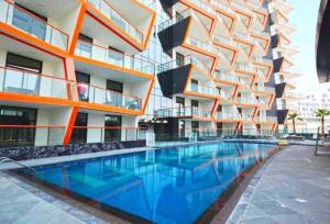 a building with a swimming pool in front of a building at Key View - Binghatti Avenue, Al Jaddaf in Dubai