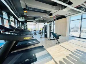 a gym with treadmills and chairs in a building at Key View - Binghatti Avenue, Al Jaddaf in Dubai