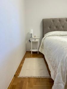 a bedroom with a bed and a table with a nightstand at Zio Nino in Sutomišćica
