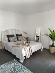 a bedroom with a bed and a table with flowers on it at Casilla de Costa in Villaverde