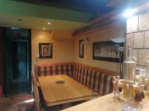 a dining room with a table and a couch at Šetnja među oblacima in Bajina Bašta