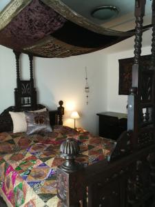 a bedroom with a bed with a quilt on it at Gästehaus Fuchsröhre in Welcherath