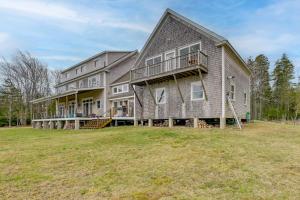 a large house with a large yard at Waterfront Deer Isle Apartment with Fire Pit in Deer Isle