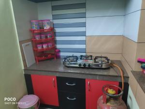 a toy kitchen with a stove top on a counter at Golden Peak Estate Homestay in Wayanad