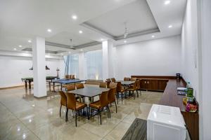 a dining room with tables and chairs and a piano at Windsor Castle Premier Cyber City in Gurgaon