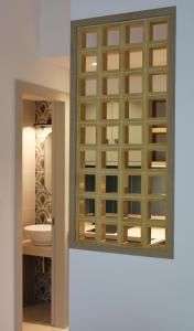 a bathroom with a mirror and a sink at Eleftheria Studios in Balíon