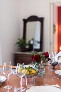 a table with glasses and a bowl of fruit and a mirror at Airy Seafront 1920s Apartment in Split