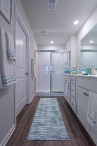 a bathroom with a shower and a sink and a glass shower stall at Endless Summer Rental in Millville