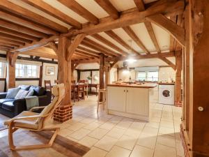 a kitchen and living room with wooden ceilings at Wren Cottage in Canterbury