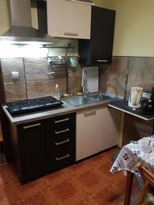 a small kitchen with a sink and a stove at VIP in Ahtopol