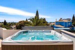 a hot tub on the balcony of a house at Casa Pitanga in Carvoeiro