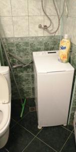 a bathroom with a toilet and a small refrigerator at VIP in Ahtopol