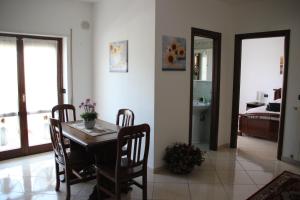 a dining room with a table and chairs and a bedroom at Il Girasole - Apartment in Avezzano