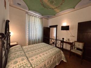 um quarto com uma cama, uma mesa e um tecto em Camere Gozzante em Pienza