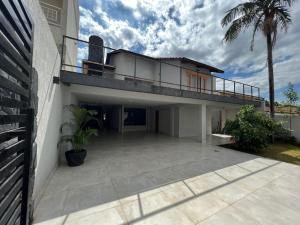 a house with a balcony and a patio at Casa Malta - St Sul in Goiânia