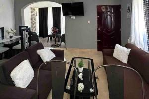 a living room with a couch and a table at Casa Linda - 10 mins from Beach & Lagoon with AC & Free Parking in Payita