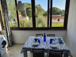 a table with a blue and white table cloth on it at Mare Fuori Lacona in Capoliveri