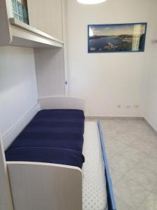 a small room with a bed in the corner at Mare Fuori Lacona in Capoliveri