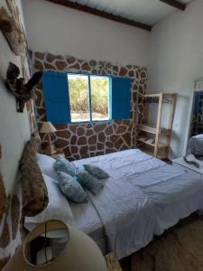 a bedroom with a large bed with blue pillows at Villa Mediterránea in Tubará
