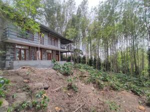 a house in the middle of a forest at Cholai Resorts & Hotels in Yercaud