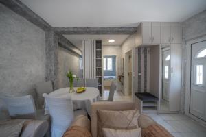 a living room with a white table and chairs at Apartman Anja in Risan