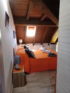 a bedroom with an orange bed in a attic at Appartamento Fiuggi Terme in Fiuggi