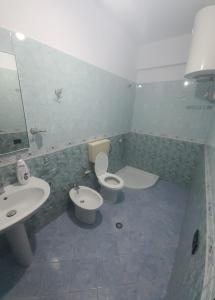 a bathroom with a toilet and a sink at Hotel Blue Eyes in Vlorë
