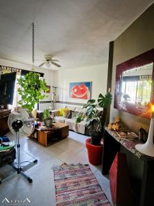 a living room with a couch and a fan at Tu Casa en el Caribe in Cancún