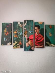 a painting of a woman with butterflies on a wall at Tu Casa en el Caribe in Cancún
