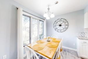a dining room with a table and a clock on the wall at Turtle Cove 4839 in Kiawah Island