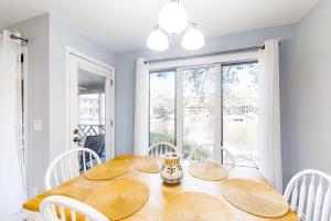 a dining room with a table and chairs and a window at Turtle Cove 4839 in Kiawah Island