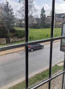 a view from a window of a car driving down a street at Cowpers Oak in Olney
