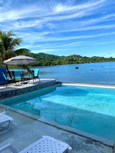 a swimming pool with a view of the water at ScubaPortobelo in Portobelo