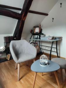 uma sala de estar com uma cadeira e uma mesa em Rouen em Rouen