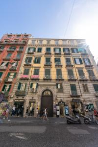 a large building with people walking in front of it at Appartamento Via Toledo 55 - Palazzo della Porta in Naples