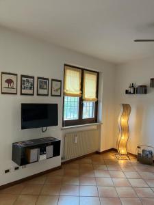 a living room with a flat screen tv on the wall at Residence Gli Ulivi in Castion Veronese