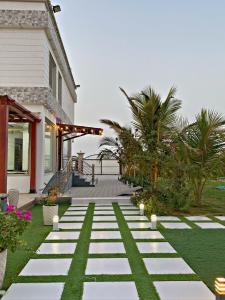 a house with a walkway in front of a house at 4 bedroom Yasmin Garden in Barka