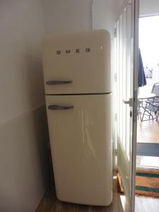 einen weißen Kühlschrank in einem Zimmer mit einem Tisch in der Unterkunft Lovely 1 bedroom apartment with kitchen and pool in Albox