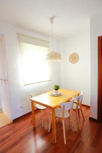 een eettafel en stoelen in een kamer bij ÁTICO RESIDENCIAL MARIANA parking privado y piscina in Rincón de la Victoria