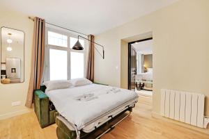 um quarto com uma cama e uma grande janela em Superb apartment 4 people center of Paris em Paris