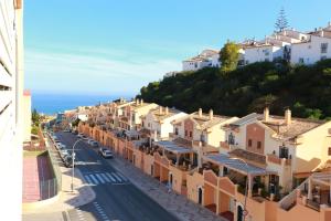 uitzicht op een straat in een stad met huizen bij ÁTICO RESIDENCIAL MARIANA parking privado y piscina in Rincón de la Victoria