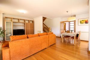 a living room with a couch and a table at El refugio home in Santander