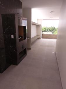 a large room with a tile floor and a black cabinet at Monoambiente totalmente equipado in Santa Cruz de la Sierra