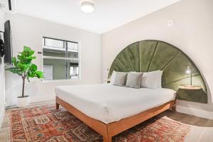 a bedroom with a large bed and a window at Roami at The Carmela in Miami Beach