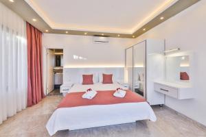 a bedroom with a large white bed with towels on it at Villa Likya Honeymoon in Kalkan