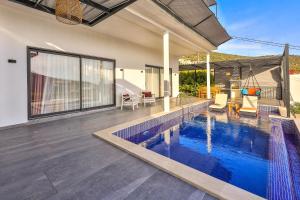 a swimming pool in the middle of a house at Villa Likya Honeymoon in Kalkan