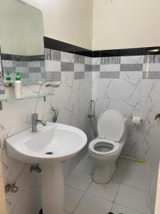a bathroom with a sink and a toilet and a mirror at Valhalla Resort Kumrat in Tāl