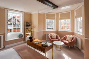 a living room with two chairs and a table at The George Hotel in Buckden