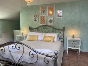 a bedroom with a bed and a nightstand with two lamps at Appartamento castelli Romani - con vista su ROMA in Monte Porzio Catone